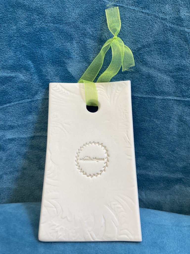 Ceramic rectangle with green handing ribbon to diffuse oils from