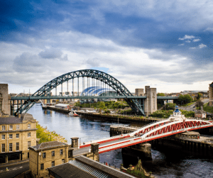 An image of Newcastle featuring the Quayside, the swing bridge, and green bridge.
