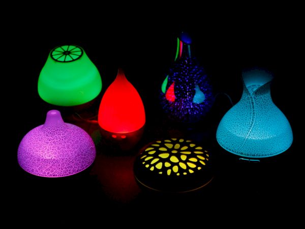 Aroma Diffusers light up different colours on a black back ground
