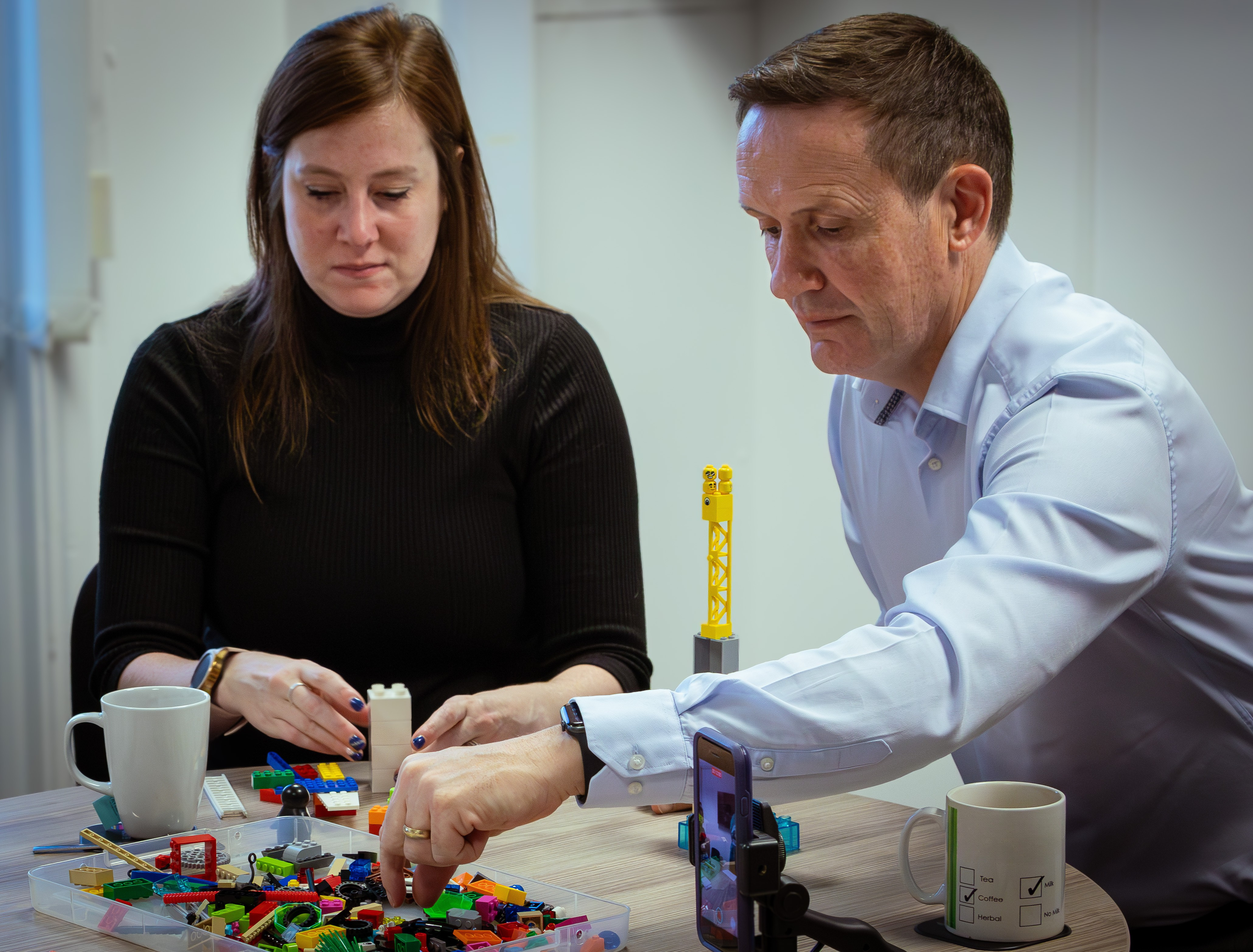 Two team members working together through a LEGO SERIOUS PLAY workshop