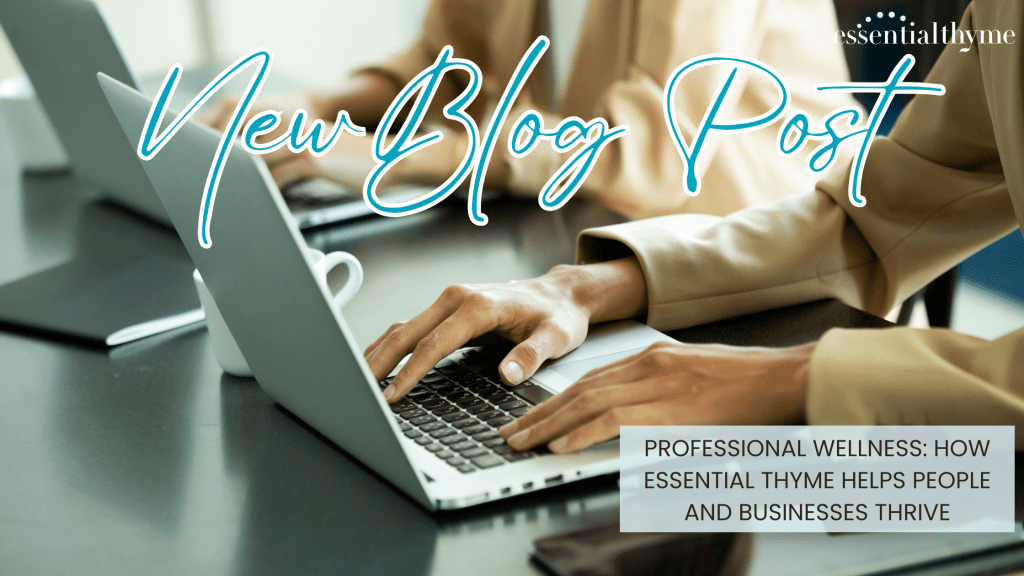 People working on a desk on a laptop in an office -Professional Wellness: How Essential Thyme Helps People and Businesses Thrive
